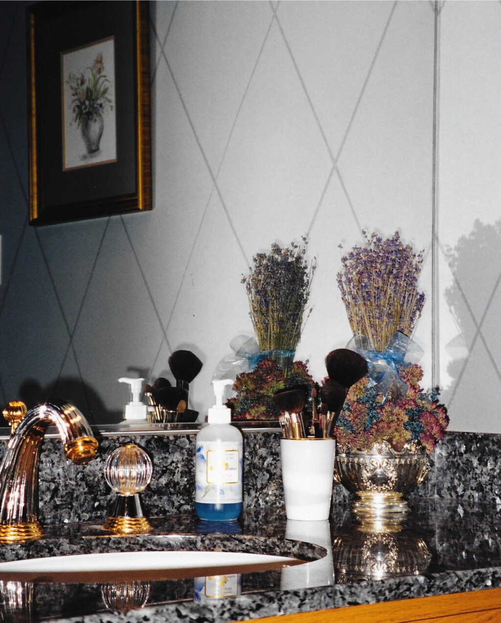 Hand modeled wall treatment with harlequin detail, blue pearl counter tops, crystal globe faucet handles. Transitional interior design
